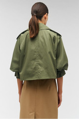 Profile view of model wearing the Oroton Crop Trench in Green Olive and 65% polyester, 35% cotton for Women