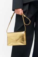 Profile view of model wearing the Oroton Mia Texture Clutch in Gold Metallic and Metallic textured leather for Women