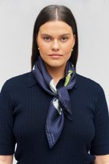 Profile view of model wearing the Oroton Snowball Silk Scarf in North Sea and 100% silk for Women