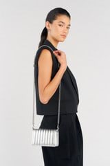 Profile view of model wearing the Oroton Fay Mini Chain Crossbody in Silver and Metallic Leather for Women