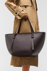 Profile view of model wearing the Oroton Ellis Medium Tote in Mahogany and Smooth leather for Women