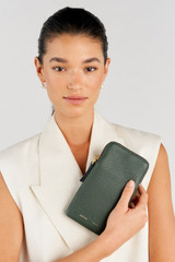 Profile view of model wearing the Oroton Lilly Phone Crossbody in Fern and Pebble leather for Women