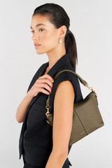 Profile view of model wearing the Oroton Lilly Zip Top Crossbody in Olive and Pebble leather for Women