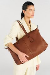 Profile view of model wearing the Oroton Lilly Weekender Tote in Cognac and Pebble leather for Women