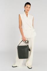 Profile view of model wearing the Oroton Lilly Hobo Bag in Fern and Pebble leather for Women