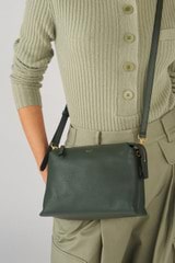 Profile view of model wearing the Oroton Sadie Crossbody in Fern and Pebble Leather for Women