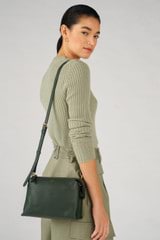 Profile view of model wearing the Oroton Sadie Crossbody in Fern and Pebble Leather for Women