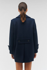 Profile view of model wearing the Oroton Double Breasted Pea Coat in North Sea and 50% wool, 50% polyester for Women
