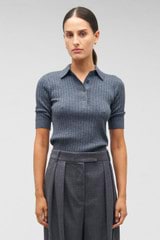 Profile view of model wearing the Oroton Stitch Rib Polo in Charcoal Marle and 100% wool for Women