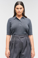 Profile view of model wearing the Oroton Stitch Rib Polo in Charcoal Marle and 100% wool for Women