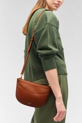 Profile view of model wearing the Oroton Florence Crossbody in Cognac and Smooth leather for Women