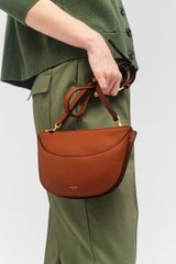 Profile view of model wearing the Oroton Florence Crossbody in Cognac and Smooth leather for Women