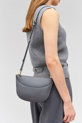 Profile view of model wearing the Oroton Florence Crossbody in Grey Flannel and Smooth leather for Women