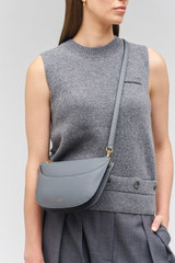 Profile view of model wearing the Oroton Florence Crossbody in Grey Flannel and Smooth leather for Women