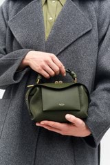 Profile view of model wearing the Oroton Mica Mini Bowler

 in Dark Khaki and Pebble leather for Women