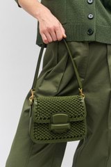 Profile view of model wearing the Oroton Carter Collectable Small Day Bag in Dark Khaki and Smooth leather, handwoven leather for Women