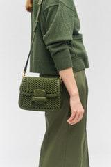Profile view of model wearing the Oroton Carter Collectable Small Day Bag in Dark Khaki and Smooth leather, handwoven leather for Women