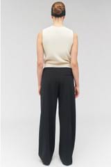 Profile view of model wearing the Oroton Contrast Waist Pant in Black and 53% poly, 42% wool, 5% elastane for Women