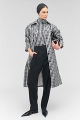 Profile view of model wearing the Oroton Check Trench in Black/White and 100% recycled polyester for Women