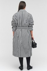 Profile view of model wearing the Oroton Check Trench in Black/White and 100% recycled polyester for Women