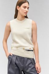 Profile view of model wearing the Oroton Button Detail Shell Knit in Cream and 100% wool for Women