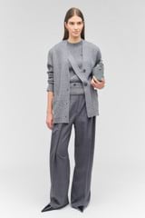 Profile view of model wearing the Oroton Button Detail Long Line Cardigan in Grey Marle and 100% wool for Women