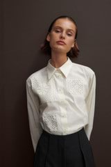 Profile view of model wearing the Oroton Doilie Detail Overshirt in Cream and 100% cotton for Women