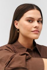 Profile view of model wearing the Oroton Julie Large Knot Hoops in 18K Gold Vermeil and Sustainably sourced 925 Sterling Silver for Women