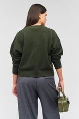 Profile view of model wearing the Oroton Long Sleeve Boxy Cardigan in Green Olive and 100% wool for Women