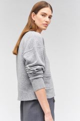 Profile view of model wearing the Oroton Long Sleeve Boxy Cardigan in Light Grey Marle and 100% wool for Women