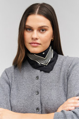 Profile view of model wearing the Oroton Bandana Silk Scarf in Black and 100% silk for Women