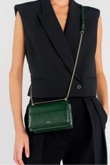 Profile view of model wearing the Oroton Forte Micro Clutch in Juniper and Textured leather for Women