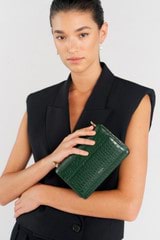 Profile view of model wearing the Oroton Forte Micro Clutch in Juniper and Textured leather for Women