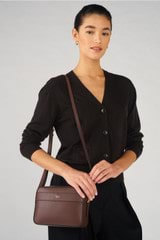 Profile view of model wearing the Oroton Harvey Camera Crossbody in Chestnut and Smooth leather for Women