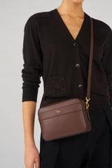 Profile view of model wearing the Oroton Harvey Camera Crossbody in Chestnut and Smooth leather for Women