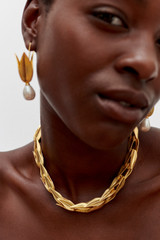 Profile view of model wearing the Oroton Alma Necklace in Worn Gold and Brass for Women