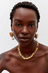 Profile view of model wearing the Oroton Alma Hook Earrings in Worn Gold/Pearl and Brass for Women