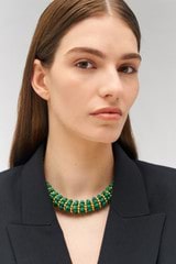 Profile view of model wearing the Oroton Pietra Necklace in 18K Worn Gold/Malachite and Brass for Women