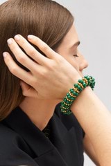 Profile view of model wearing the Oroton Pietra Bracelet in 18K Worn Gold/Malachite and Brass for Women