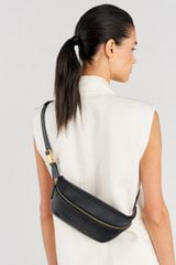 Profile view of model wearing the Oroton Lilly Belt Bag in Black and Smooth leather for Women