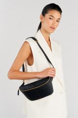 Profile view of model wearing the Oroton Lilly Belt Bag in Black and Smooth leather for Women