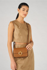 Profile view of model wearing the Oroton Ali Small Day Bag in Cognac and Smooth leather for Women