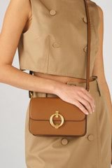 Profile view of model wearing the Oroton Ali Small Day Bag in Cognac and Smooth leather for Women