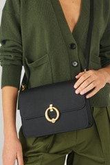 Profile view of model wearing the Oroton Ali Medium Satchel in Black and Smooth leather for Women