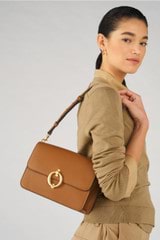 Profile view of model wearing the Oroton Ali Medium Satchel in Cognac and Smooth leather for Women