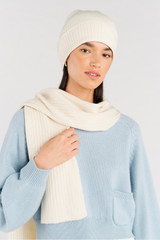 Profile view of model wearing the Oroton Eve Knit Scarf & Beanie Set in Cream and 50% acrylic, 50% wool for Women