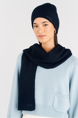 Profile view of model wearing the Oroton Eve Knit Scarf & Beanie Set in Dark Navy and 50% acrylic, 50% wool for Women