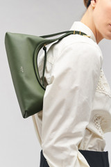 Profile view of model wearing the Oroton Cinder Mini Baguette in Moss and Smooth leather for Women