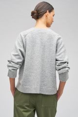 Profile view of model wearing the Oroton Boxy V Neck in Pale Grey and 44% mercerised wool, 19% cashmerer, 34% pa, 3% elastane for Women