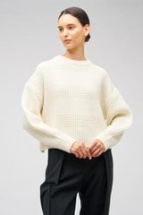 Profile view of model wearing the Oroton Stitched Crew in Cream and 100% merino wool for Women